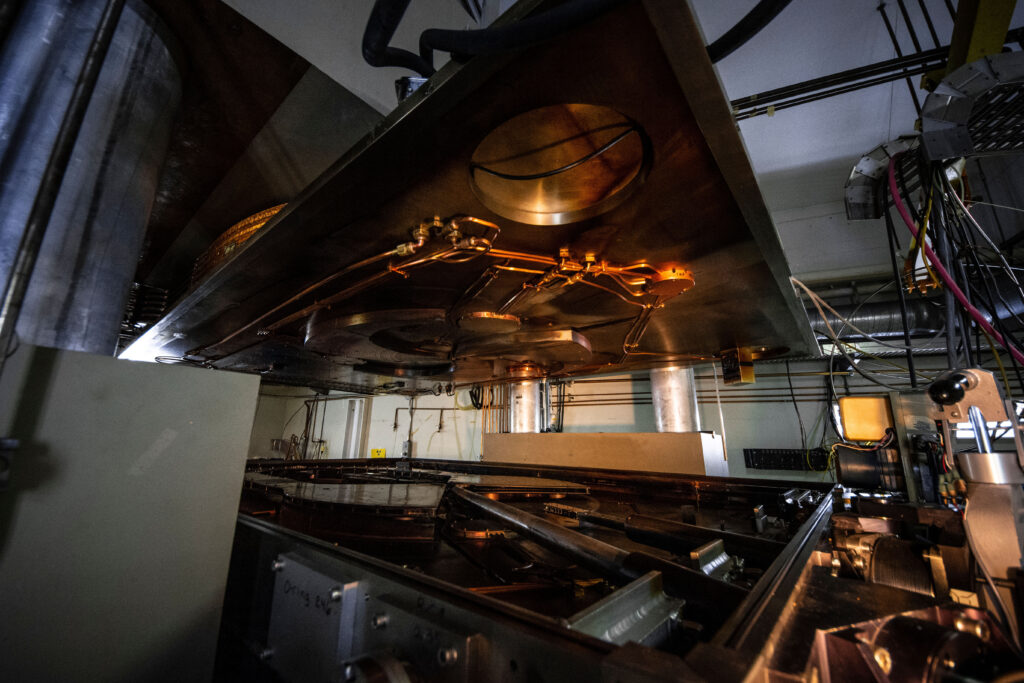 A cyclotron particle accelerator with its lid open.