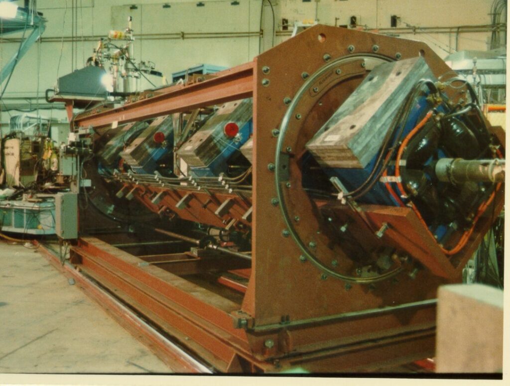 A long vacuum tube, a beamline, inset with quadrupole magnets for steering the beam.